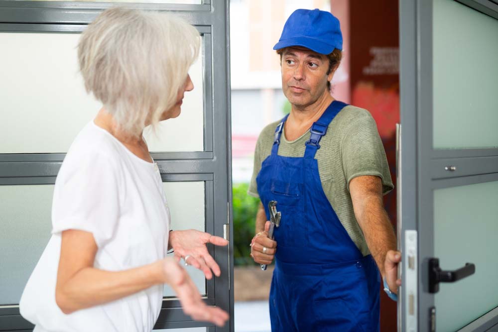 property owner talking with a plumber by the door